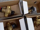 several boxes of different types of valves and fittings in a box