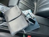 a cell phone and a wallet in a car seat
