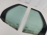 two pieces of glass sitting on top of a table next to each other