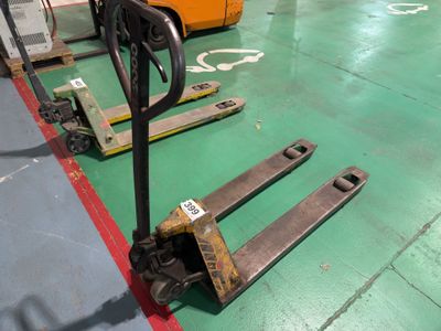 a fork lifter sitting on the floor in a warehouse
