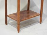 a small wooden table with a glass top on a white background