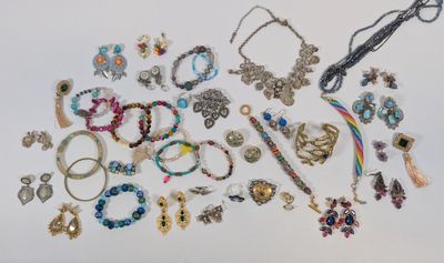many different types of jewelry on a white surface