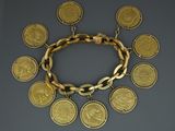 a close up of a gold bracelet with coins on it