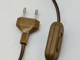 a brown cord that is connected to an electrical plug