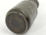 a metal object that is sitting on a white surface