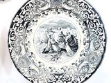 a black and white plate with a picture of a man and a woman on it