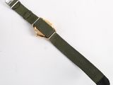 a close up of a watch on a white surface