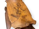 a wooden table with a carved design on top of it