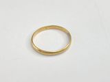a close up of a gold ring on a white surface
