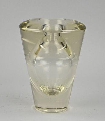 a clear glass vase with a handle on it