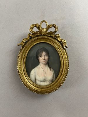 an old picture of a woman in a white dress in a gold frame