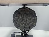 lamp with a rock on a base and a lamp shade on top of it