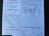 a document on the seat of a car with a barcode on it
