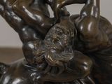 a bronze statue of a man and a woman on a horse