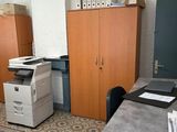 a desk with a printer and a cabinet in the room