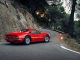 a red sports car driving down a winding road