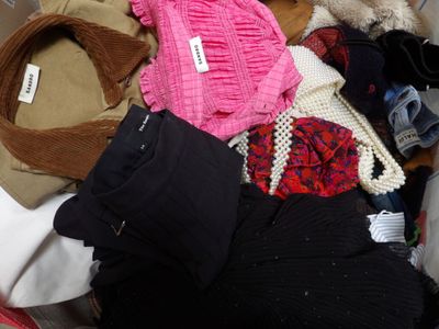 a pile of clothes that is sitting on the floor
