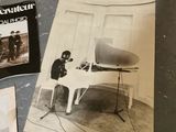a black and white photo of a man sitting at a piano