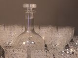 many glasses and a bottle of wine on a table