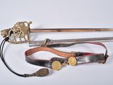 an image of a sword and other items on a white surface