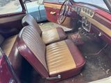an old car with a leather seat and a steering wheel
