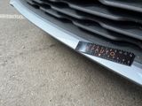a close up of a car ' s grille with a sticker on it