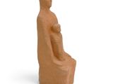 an image of a clay sculpture of a woman sitting on a chair