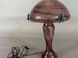 purple glass table lamp with a wooden base and a butterfly on the top