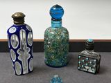 trois bouteilles en verre posées les unes à côté des autres sur une table