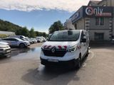 the white van is parked in front of a building with a red and white stripe on it