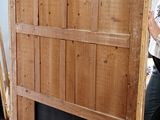 a woman that is standing next to a wooden door
