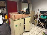 boxes are stacked on top of a wooden cabinet in a room