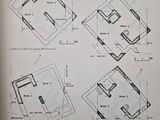 four plans of a house in a book on a table