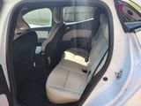 a white car with a black seat in the back of it
