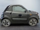 a small black car parked on a gray surface