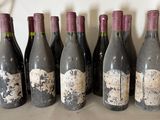 six bottles of wine are lined up in a row on a table