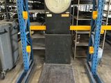 a close up of a large scale in a warehouse with lots of shelves