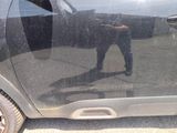 a reflection of a man in a car window