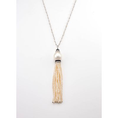 a white pearl and silver necklace with a tassel on a chain