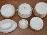 an image of a group of white dishes and cups on a table