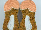 pair of orange and white slippers on a white surface