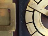 a close up of a clock that is on the wall