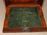 a wooden box with a green carpet inside of it
