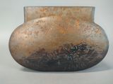 a brown vase with writing on it sitting on a table