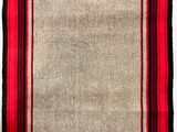 a red and beige rug with black stripes on a white background