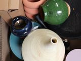 a cardboard box filled with different types of vases