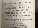 an old book with writing on it sitting on a table