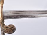 a close up of a sword with writing on it