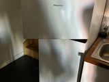 a white refrigerator and a sink in a small kitchen