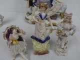 five figurines of different styles and colors on a table